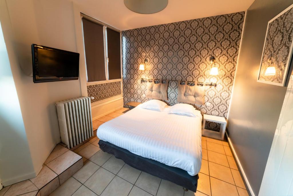 Postel nebo postele na pokoji v ubytování Hôtel Furania