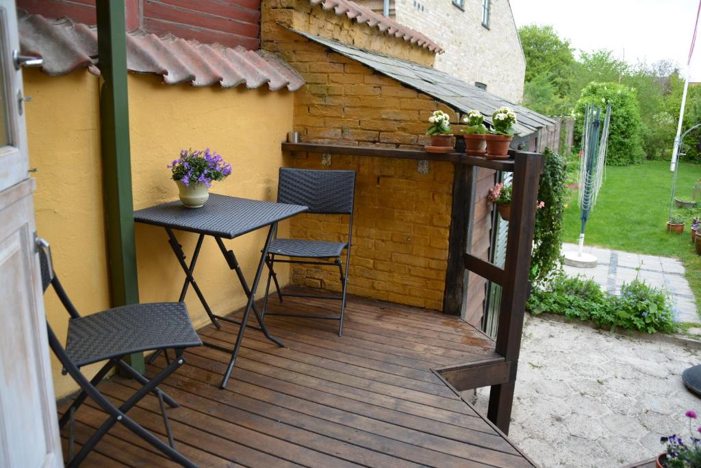 a patio with a table and chairs on a wooden deck at City House in Odense