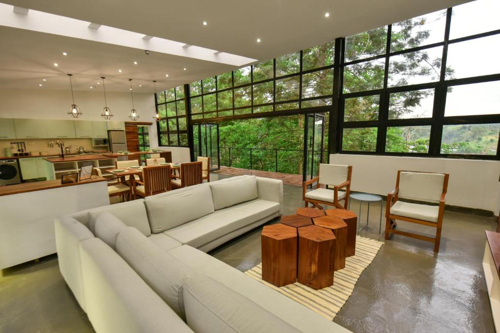 a living room with a couch and a table at The River Bank, Jinja in Jinja
