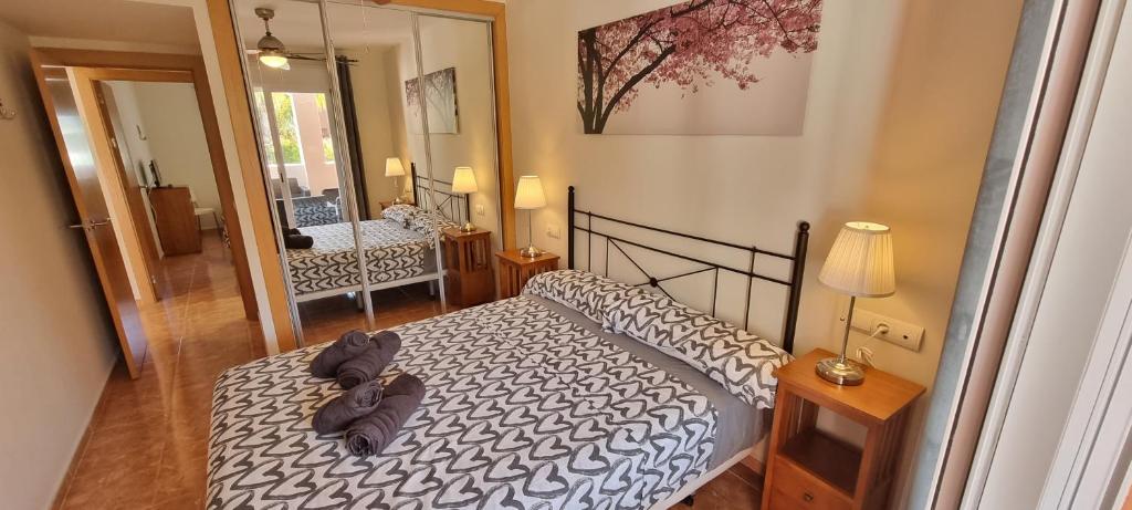 Postel nebo postele na pokoji v ubytování Homes of Spain, Apartamentos Paraíso Vera Playa, Ed Nuku Hiva, Bajo X con PISCINA PRIVADA y jardín privado a PIE de PLAYA , WIFI