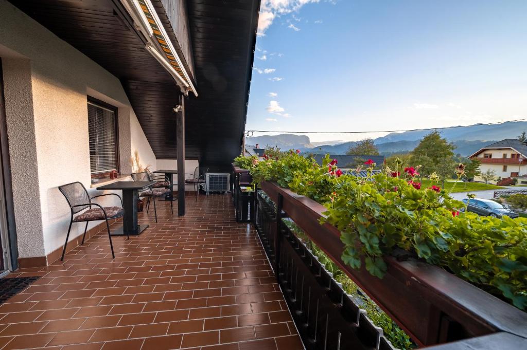 a balcony with plants and a table and chairs at APARTMA VESTER - Large 3-Bedroom Near Bled in Bled