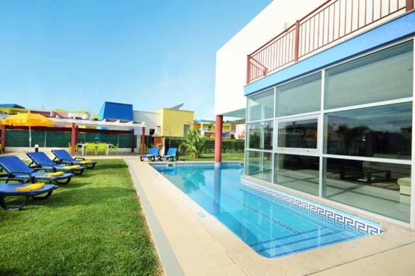 a large building with a swimming pool next to a building at Marina Sol in Albufeira