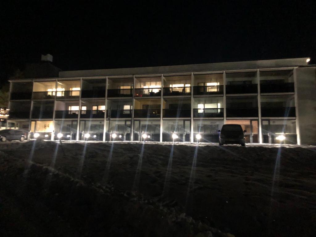 a building with a car parked in front of it at night at Ellivuori Lake View in Sastamala