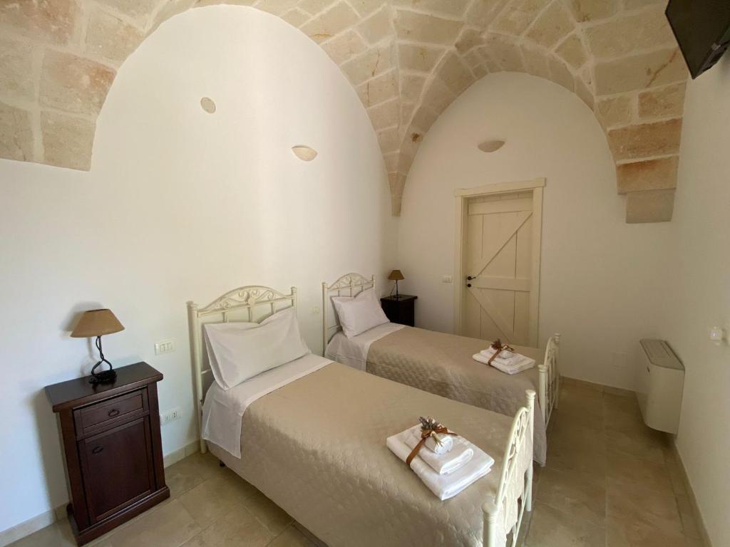 Postel nebo postele na pokoji v ubytování al vecchio ulivo