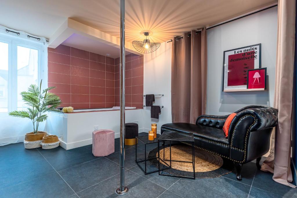 a black leather chair in a room with a window at LoveSparadise - Suite L'élixir in Chessy