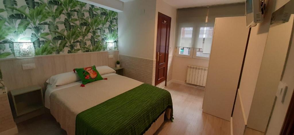 A bed or beds in a room at Hostal Verdemar