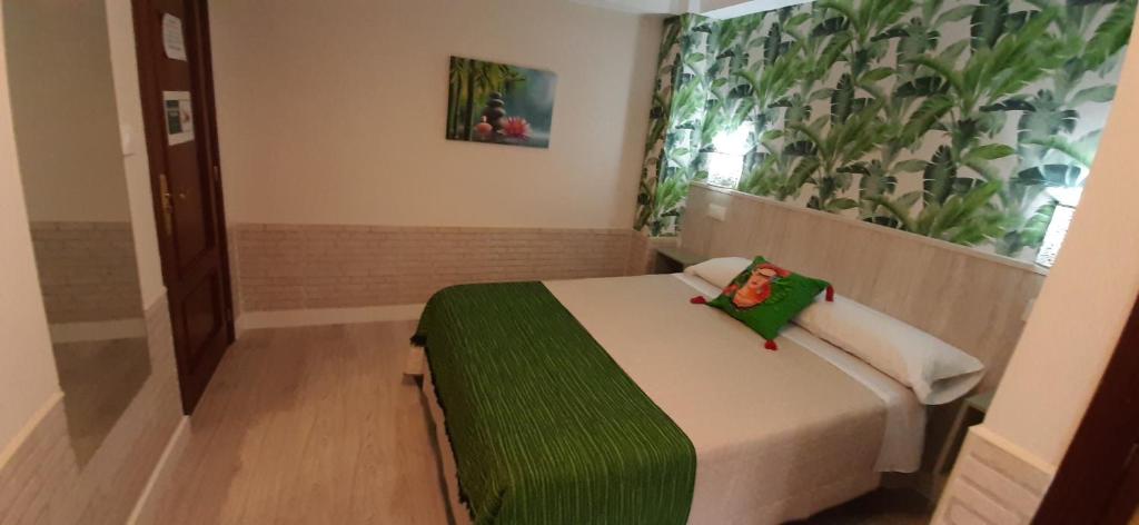 A bed or beds in a room at Hostal Verdemar