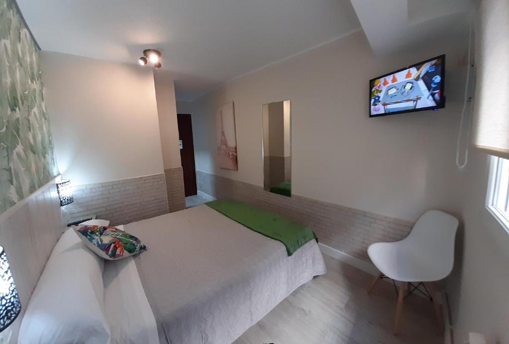 A bed or beds in a room at Hostal Verdemar