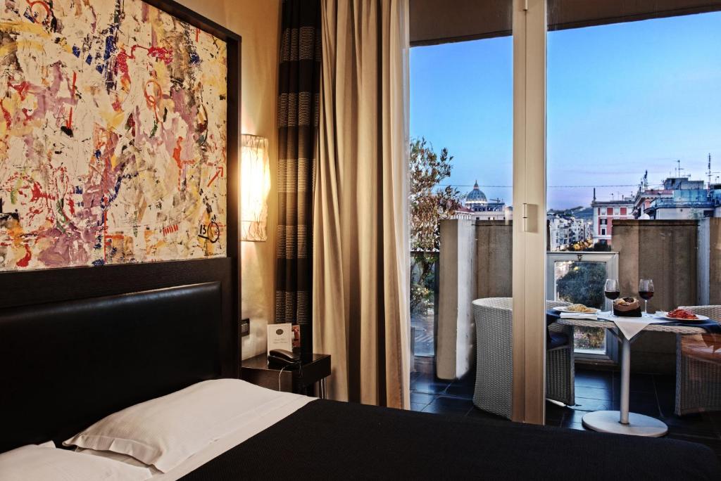 a bedroom with a bed and a large window with a view at Twentyone Hotel in Rome