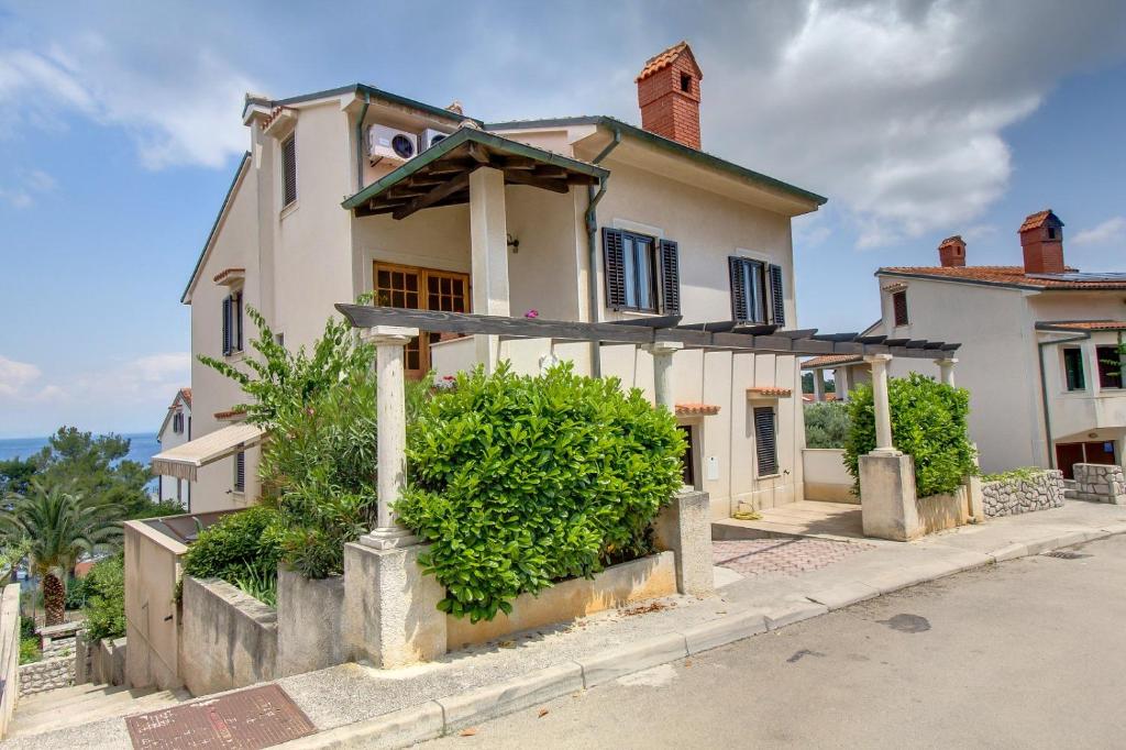 a house on the side of a street at Apartments Eli - 100 m from sea in Mali Lošinj