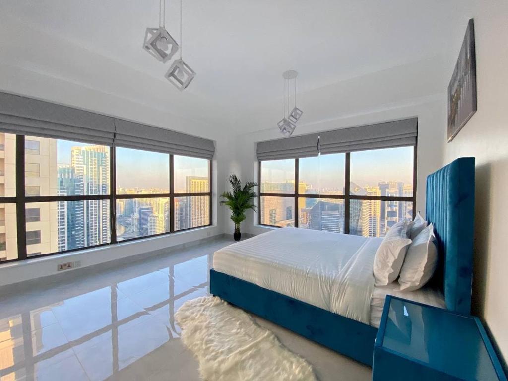 a bedroom with a large bed and a swimming pool at Luxury JBR Apartments , beach , pool , parking in Dubai