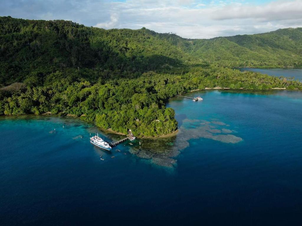 an island in the middle of a large body of water at Tawali Leisure & Dive Resort in Alotau