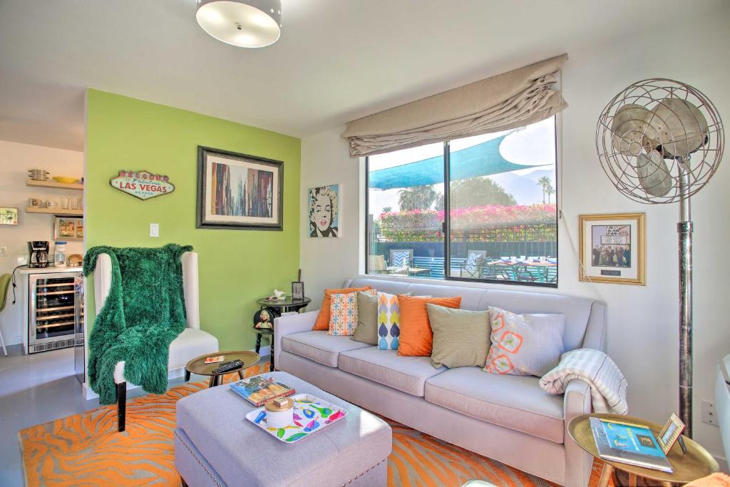 a living room with a couch and a window at Vibrant Apt with Saltwater Pool - 3 Mi to Dtwn! in Palm Springs