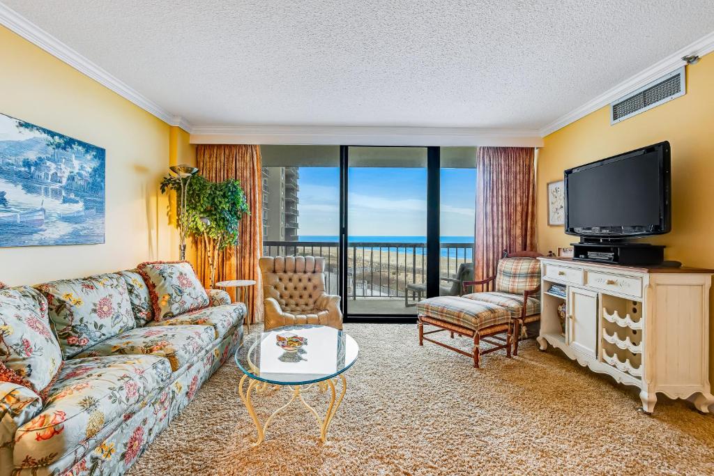 a living room with a couch and a tv at Sea Colony - Georgetowne House 409 in Bethany Beach