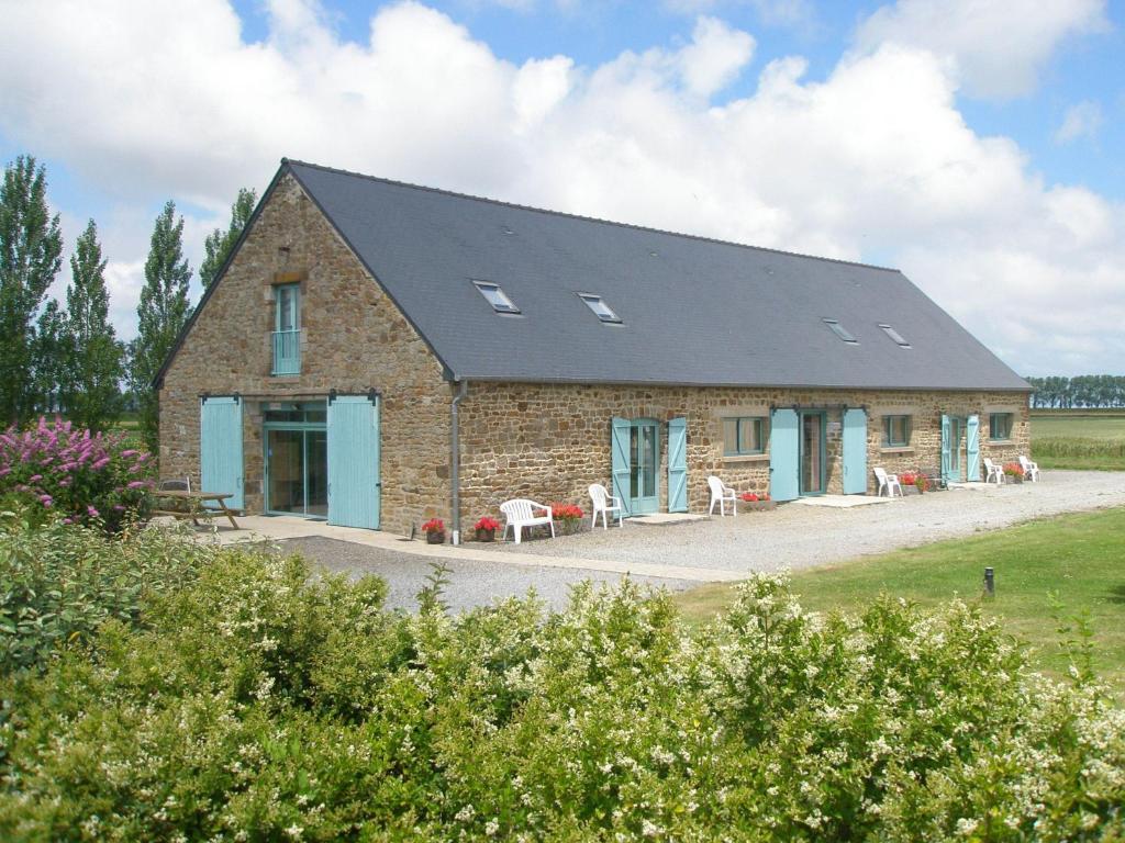 a large brick building with a black roof at Gite Couesnon in Roz-sur-Couesnon