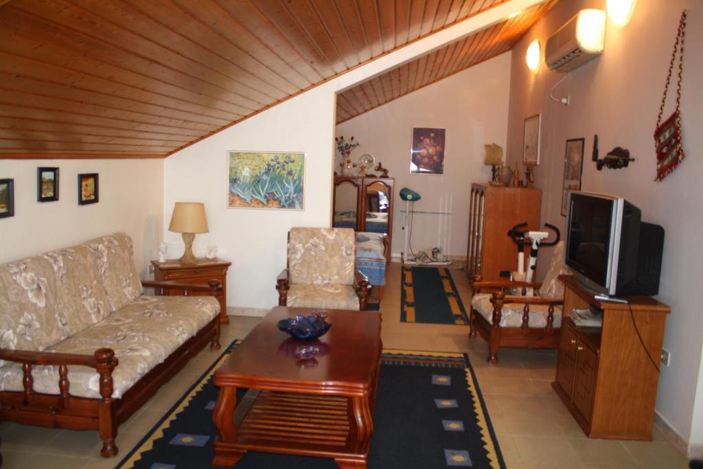 a living room with a couch and a tv at VILLA PEPETO Durres Albania in Durrës