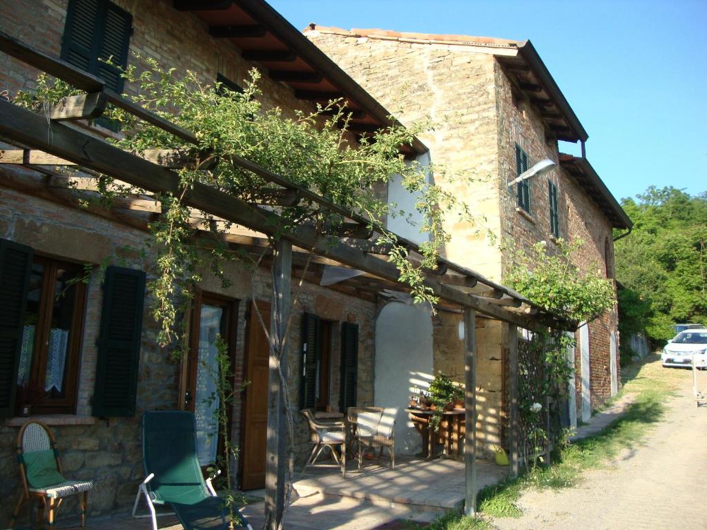 a building with a patio with chairs on it at Casa dell' Abbondanza B&B Agriturismo in Vigoleno