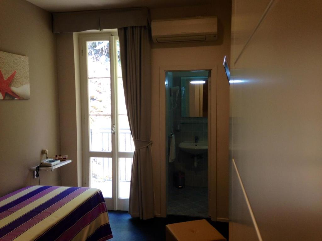 Łóżko lub łóżka w pokoju w obiekcie Hotel l'Approdo