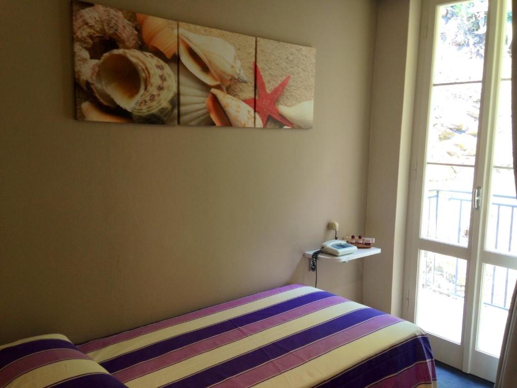 Łóżko lub łóżka w pokoju w obiekcie Hotel l'Approdo