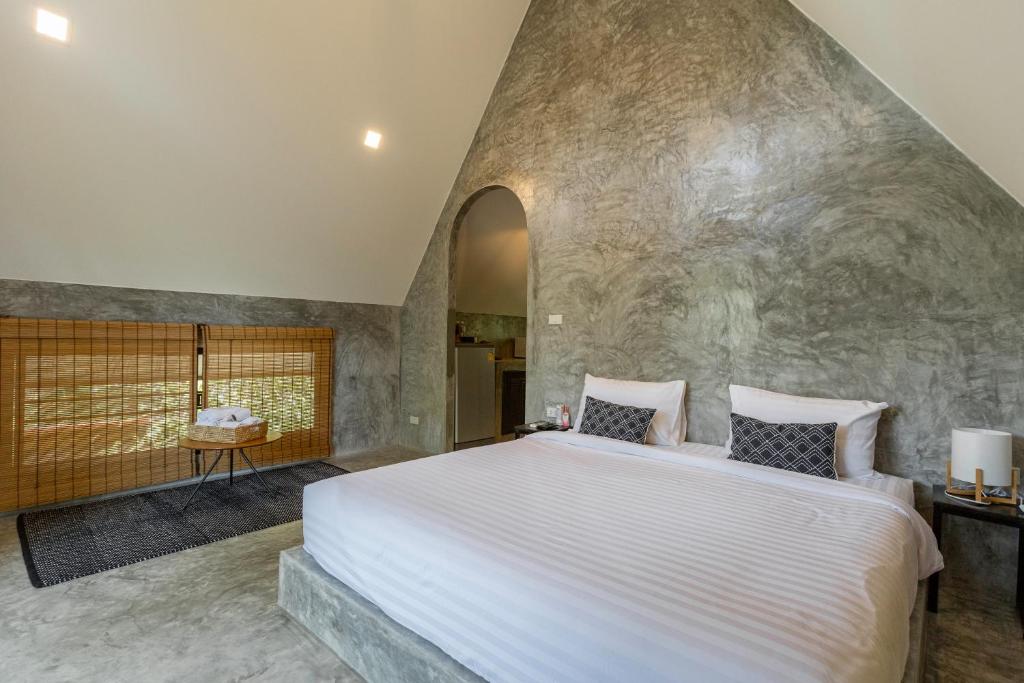 Postel nebo postele na pokoji v ubytování Baan Rai Me Rak Organic Farmstay