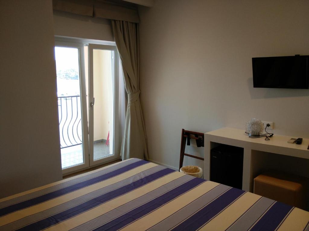 Łóżko lub łóżka w pokoju w obiekcie Hotel l'Approdo