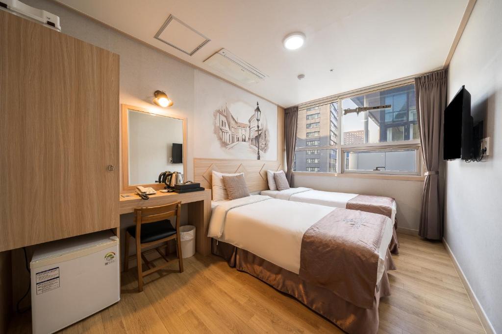 a hotel room with a bed and a desk in it at The Stay Hotel Myeongdong in Seoul