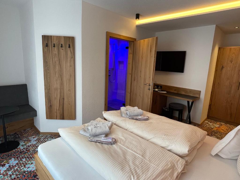 Postel nebo postele na pokoji v ubytování Hotel Grieserin