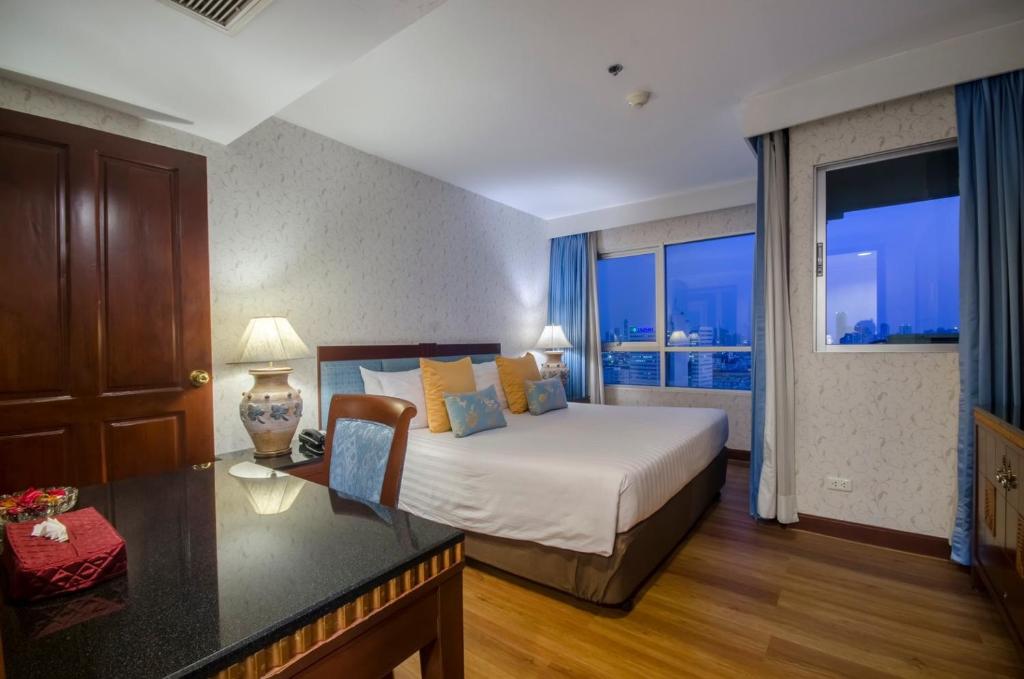 Postel nebo postele na pokoji v ubytování Prince Palace Hotel Bangkok