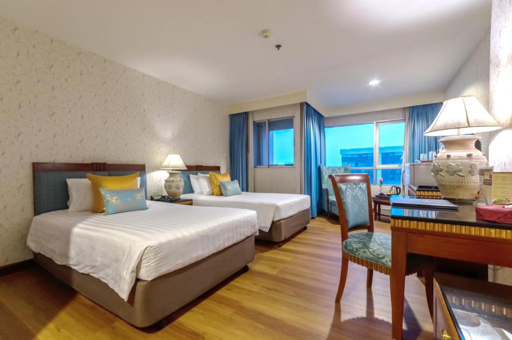 Postel nebo postele na pokoji v ubytování Prince Palace Hotel Bangkok