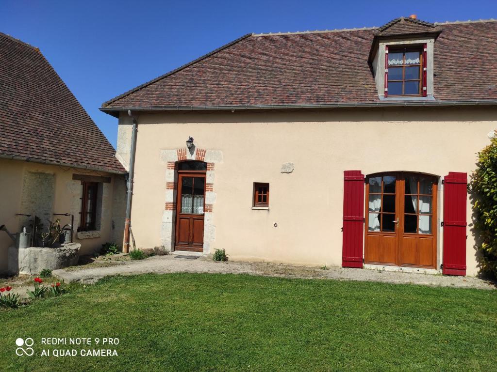 a house with red doors and a yard at Gîte Lorcy, 3 pièces, 5 personnes - FR-1-590-40 in Lorcy