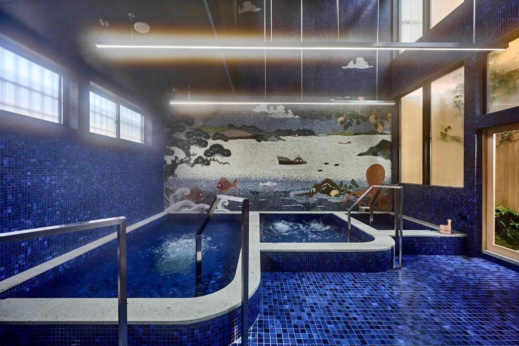 a bathroom with a jacuzzi tub in a room at yubune in Onomichi