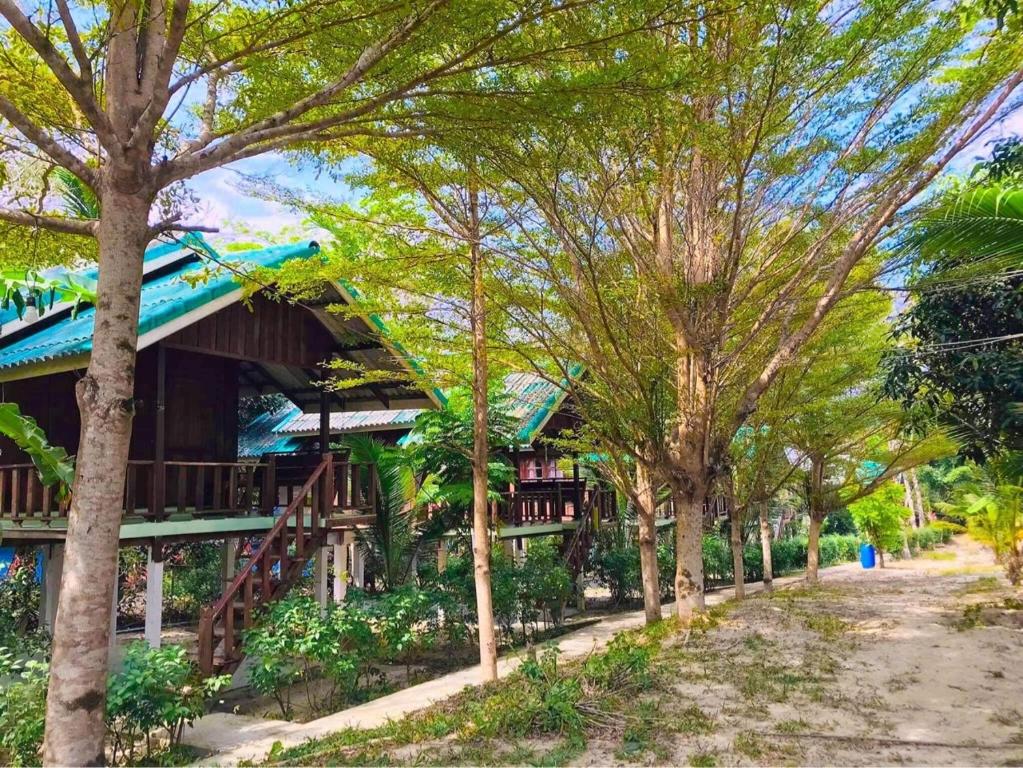 a resort with trees in front of it at Rasta House,,Koh Phayam in Ko Phayam