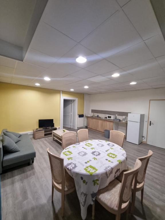 a living room with a table and chairs and a couch at Manoir de Bolbec in Bolbec