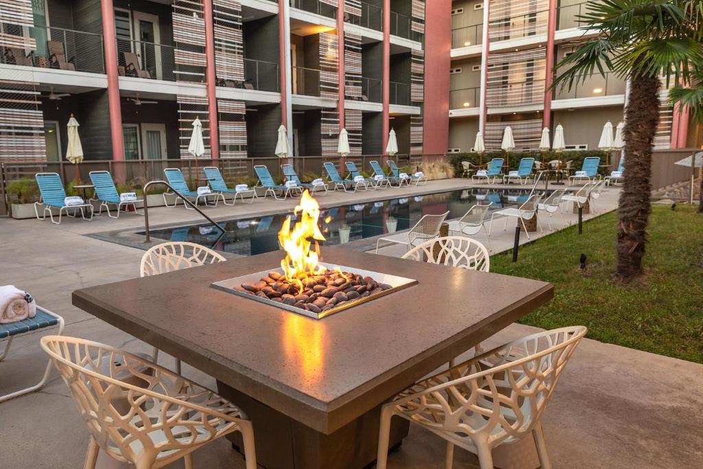 a fire pit on a table in front of a building at East Austin Hotel in Austin