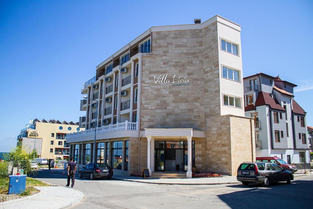 a man standing in front of a building at Villa Livia Boutique Apartments in Ravda