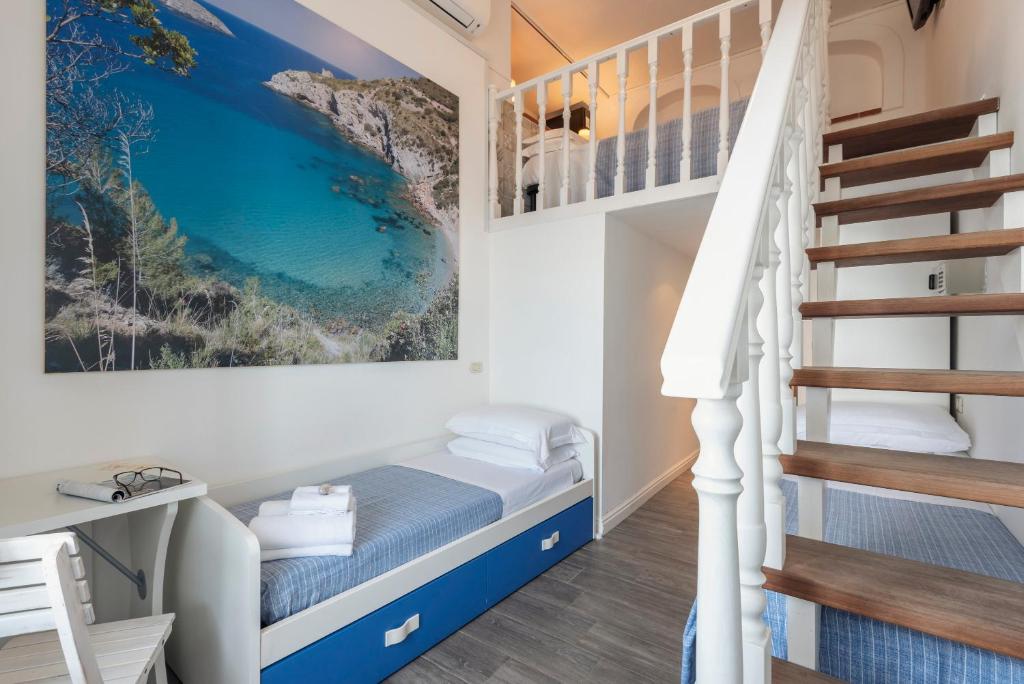Postel nebo postele na pokoji v ubytování Hotel La Caletta
