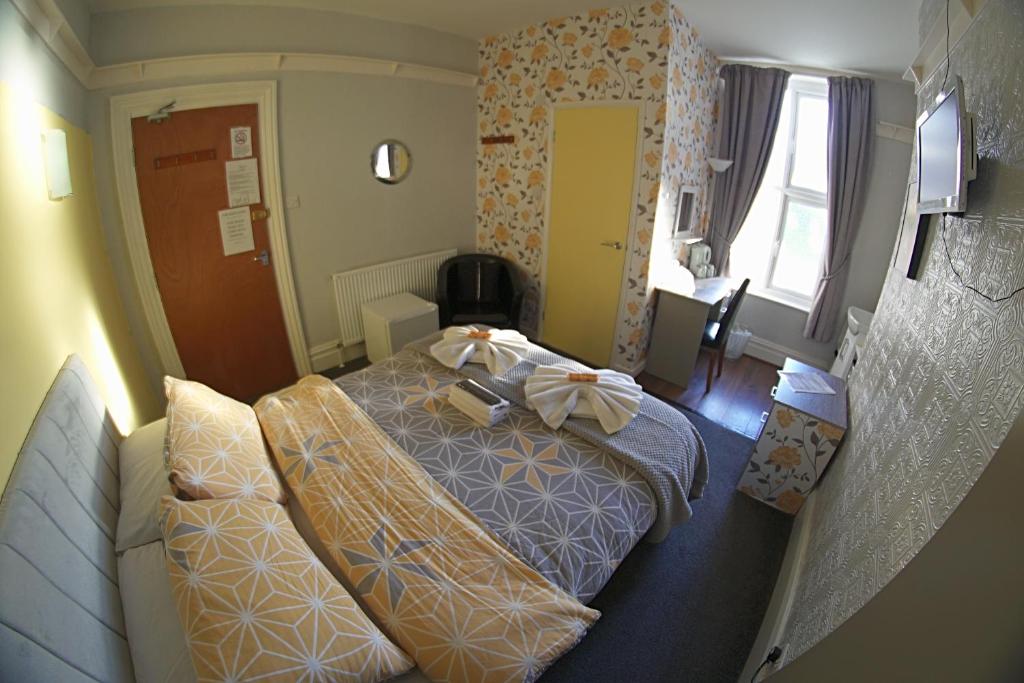 a hotel room with a bed with bows on it at The Eastleigh in Skegness