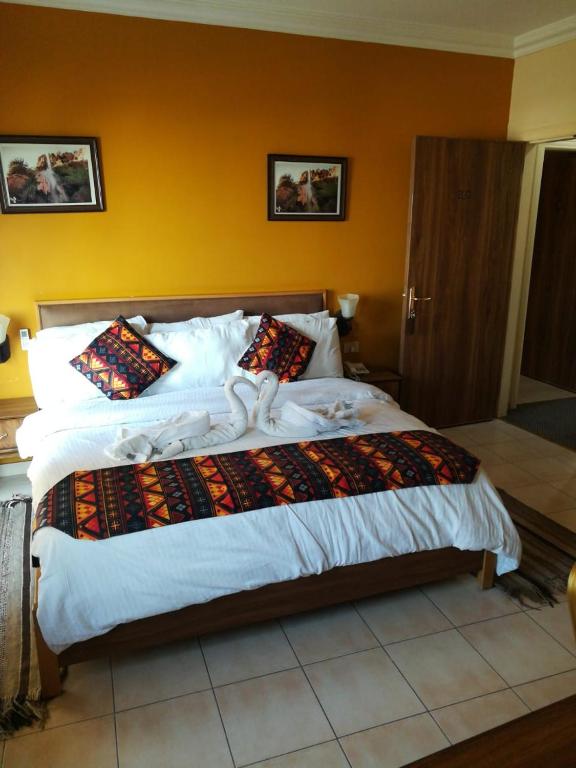 Postel nebo postele na pokoji v ubytování Mariam Hotel
