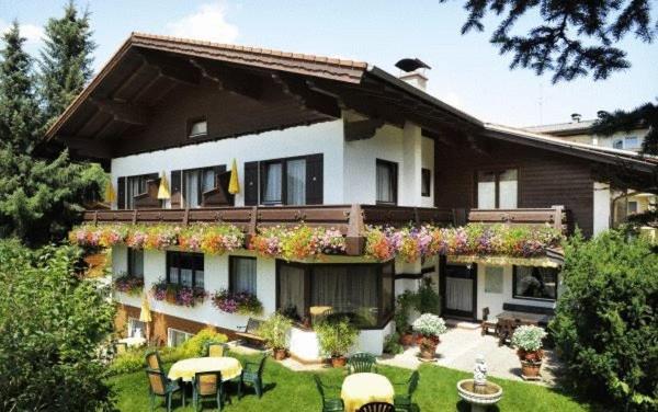 a large house with plants on the side of it at Pension Montana in Wagrain