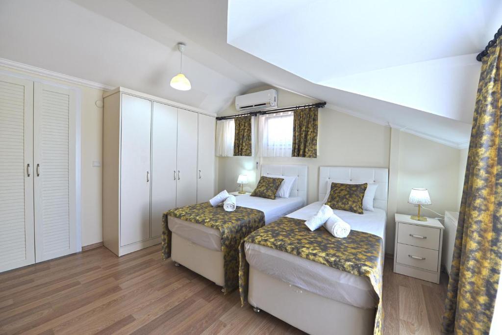 Postel nebo postele na pokoji v ubytování Ozgur City Residence