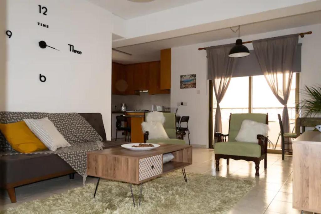 a living room with a couch and a table and chairs at Guest Apartments in Limassol