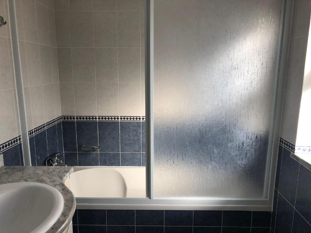 a bathroom with a shower with a tub and a sink at Camping Villa Park Zambujeira do Mar in Zambujeira do Mar