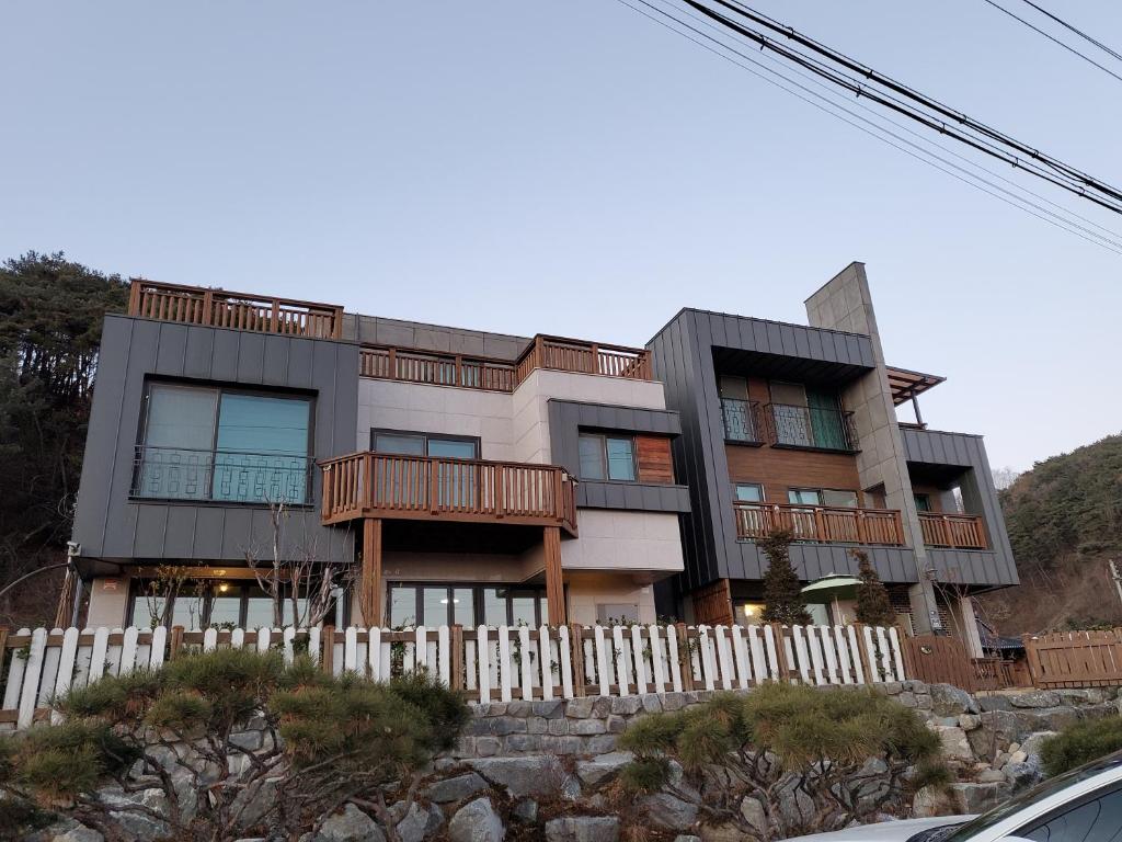 a house with a fence in front of it at Grace River House-Block B in Hoengsong