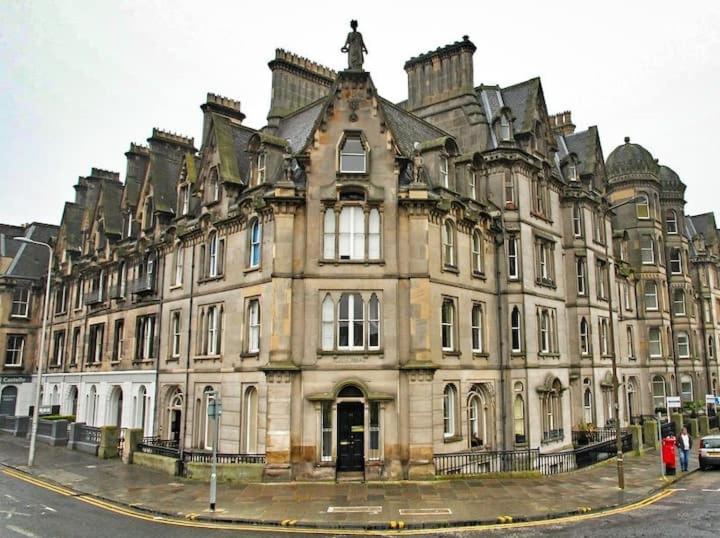 a large building on the corner of a street at Castle Terrace 1 Bed Apartment Looking onto Edinburgh Castle - Sleeps upto 4 in Edinburgh