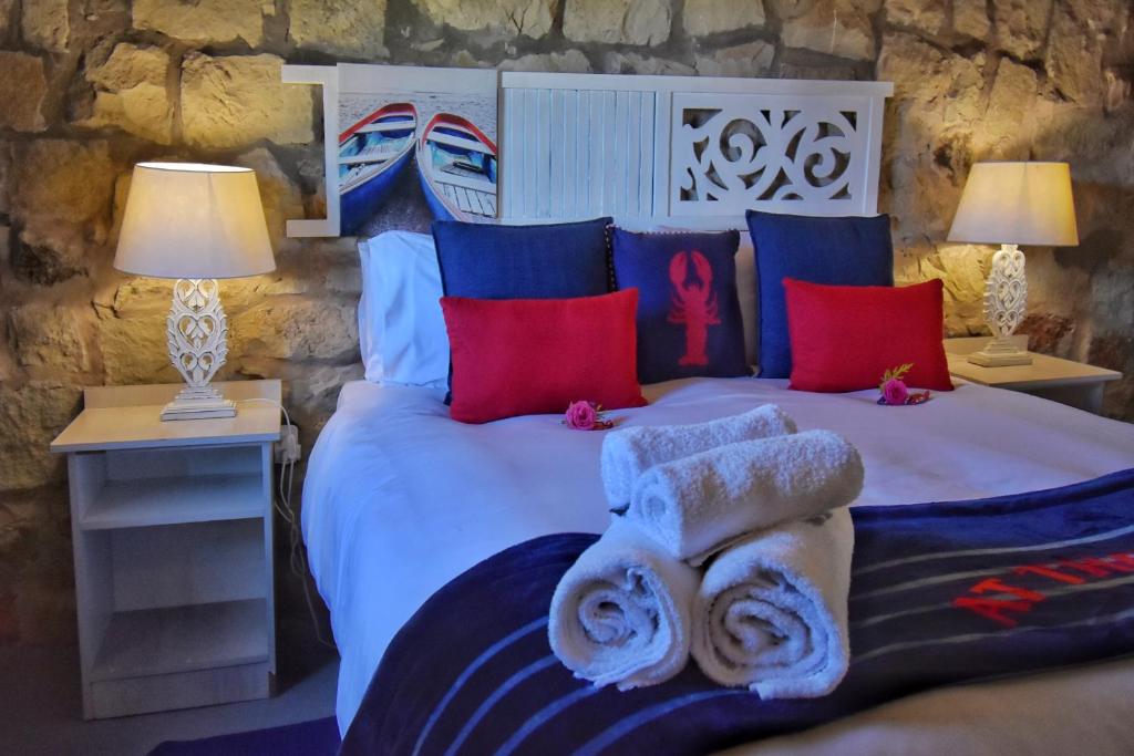 a bedroom with a bed with towels on it at Affi lande Boetiek guestfarm in Fouriesburg