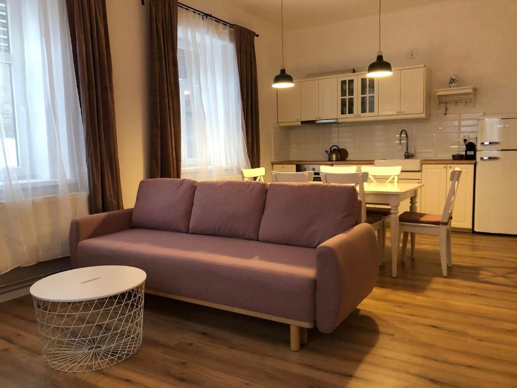 a living room with a couch and a table at Apartmán v Sedmidomku in Desná