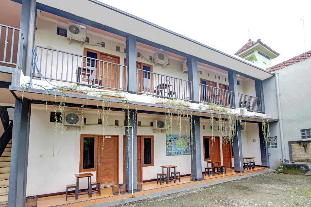 a building with tables and chairs on the balcony at Hotel Wisma CK in Kebumen
