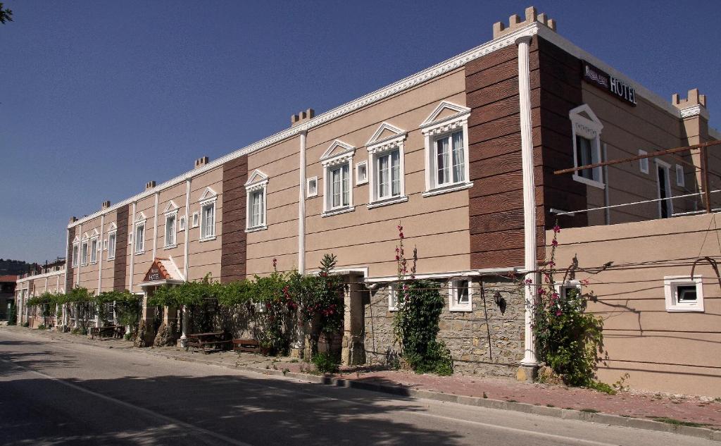 a large building on the side of a street at Aqua Boss Hotel in Eceabat