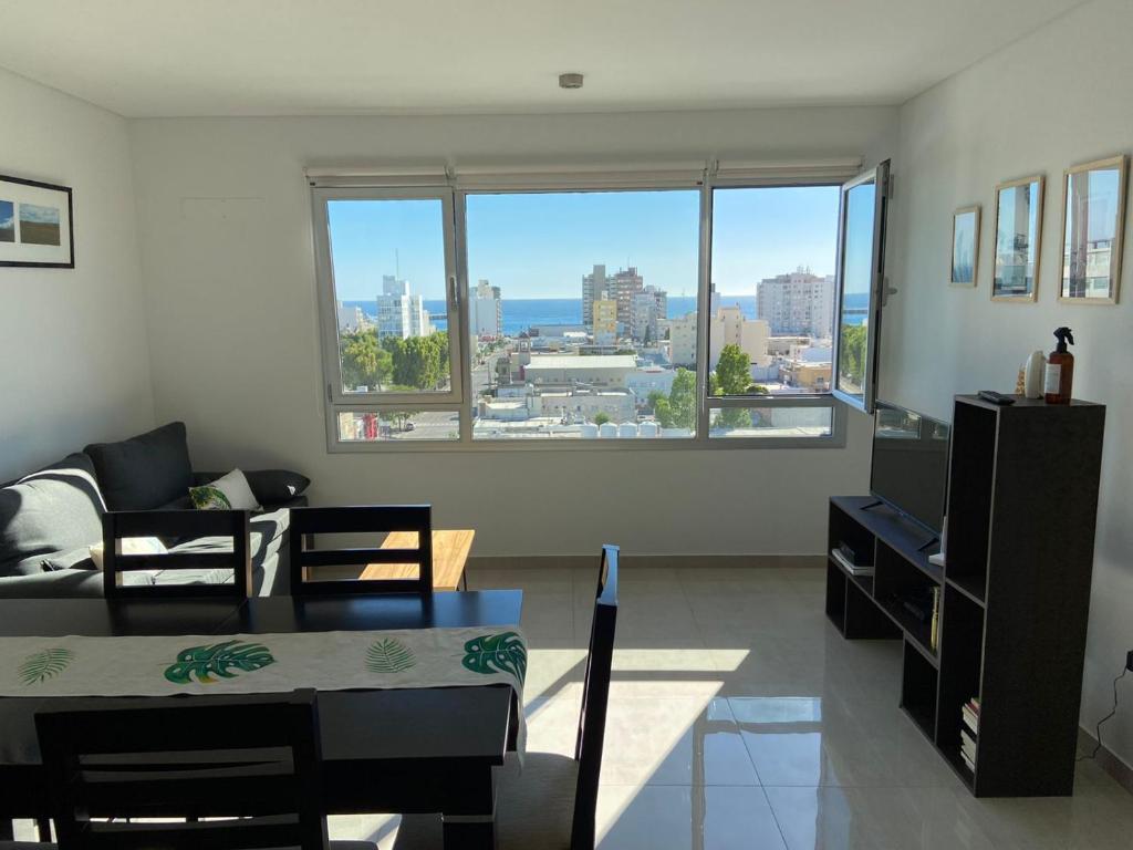 a living room with a view of a city at Departamento con vista al mar in Puerto Madryn