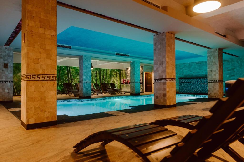 a swimming pool in a villa with a resort at Boutique Hotel Cattaleya in Bacău